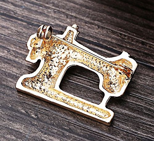 Broche, diseño de máquina de coser negro y dorado acero, costura.