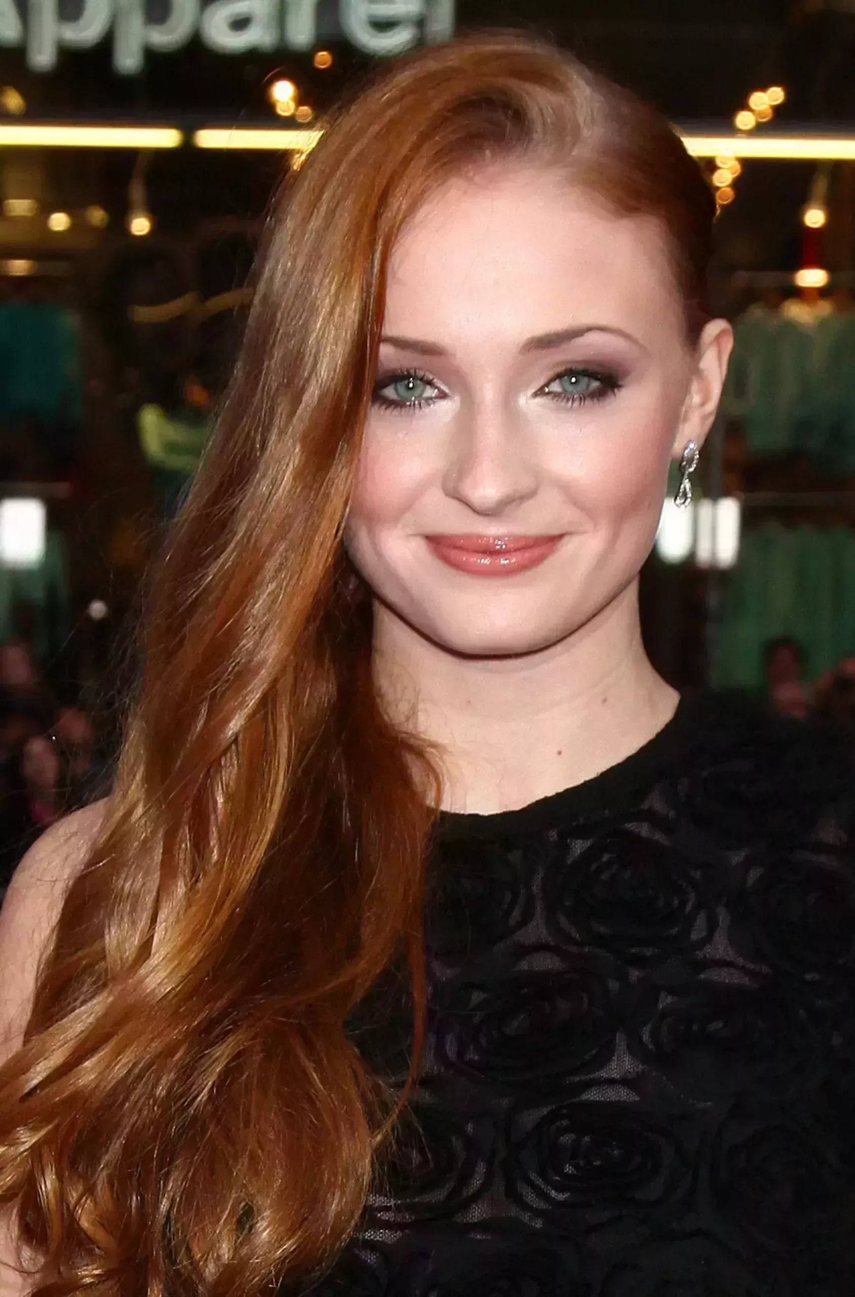 Sophie Turner’s Side Swept Red Waves