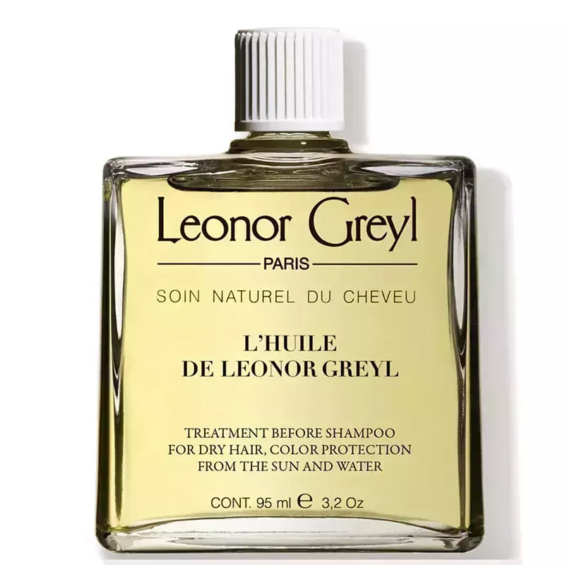 A glass square bottle of the Leonor Greyl Huile de Leonor Greyl Shampoo Treatment on a white background