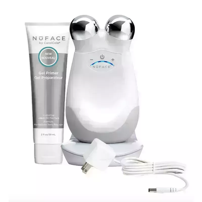 The white NuFace Trinity Facial Toning Device with a grey bottle of NuFace Priming Gel on a white background