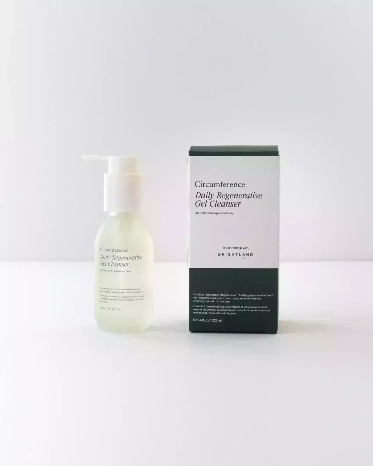 clear cleanser bottle and green and white box