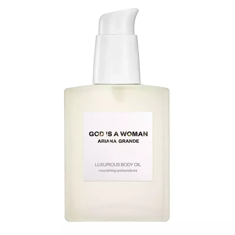 A clear square pump bottle of the Ariana Grande God Is a Woman Luxurious Body Oil on a white background