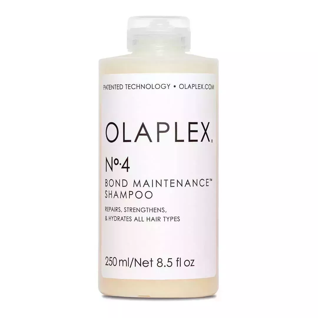 Olaplex No. 4 Bond Maintenance Shampoo transparent bottle of off white shampoo with white label on white background