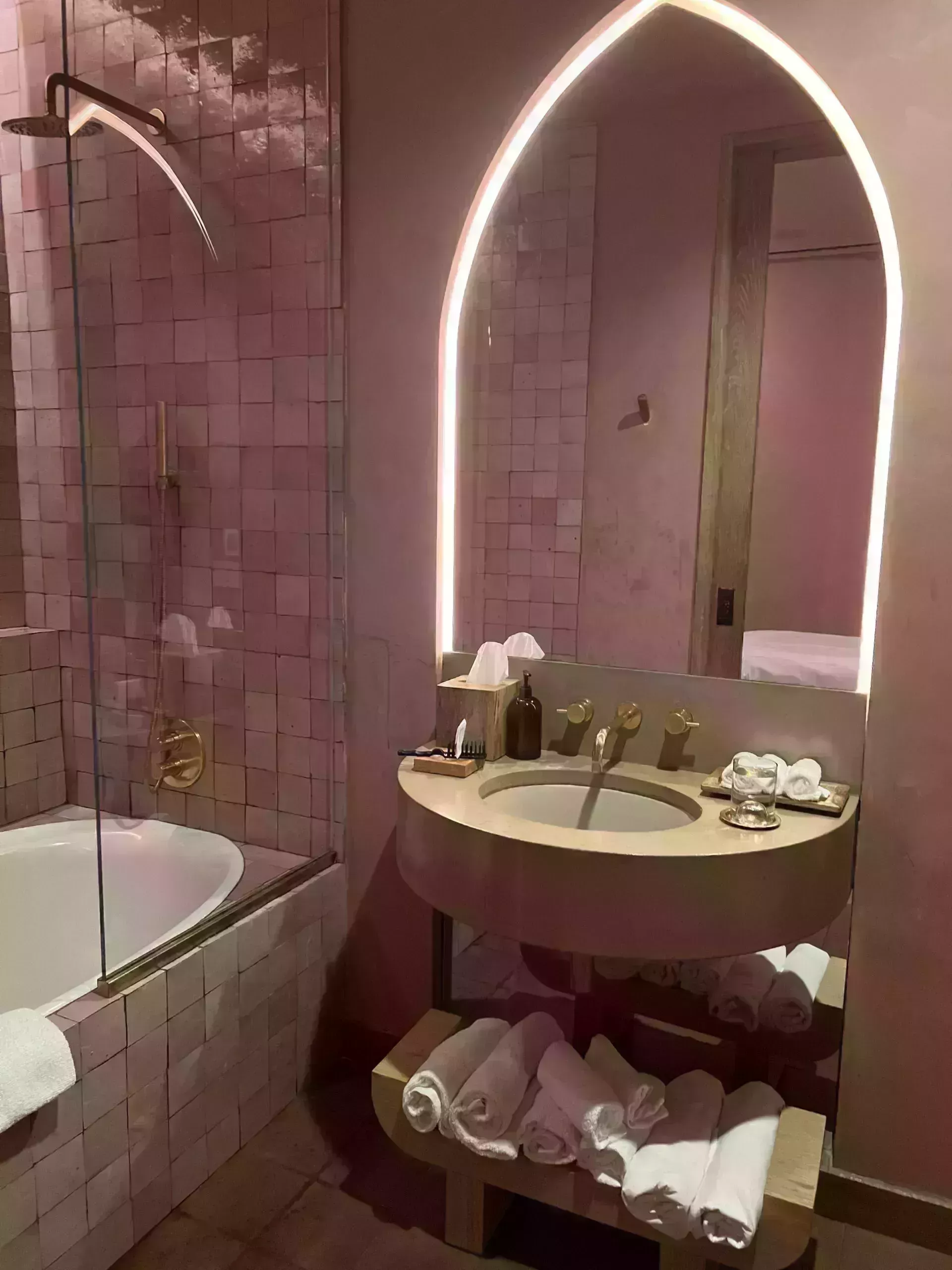 photo of a really clean beautiful bathroom with white towels and a bath tub