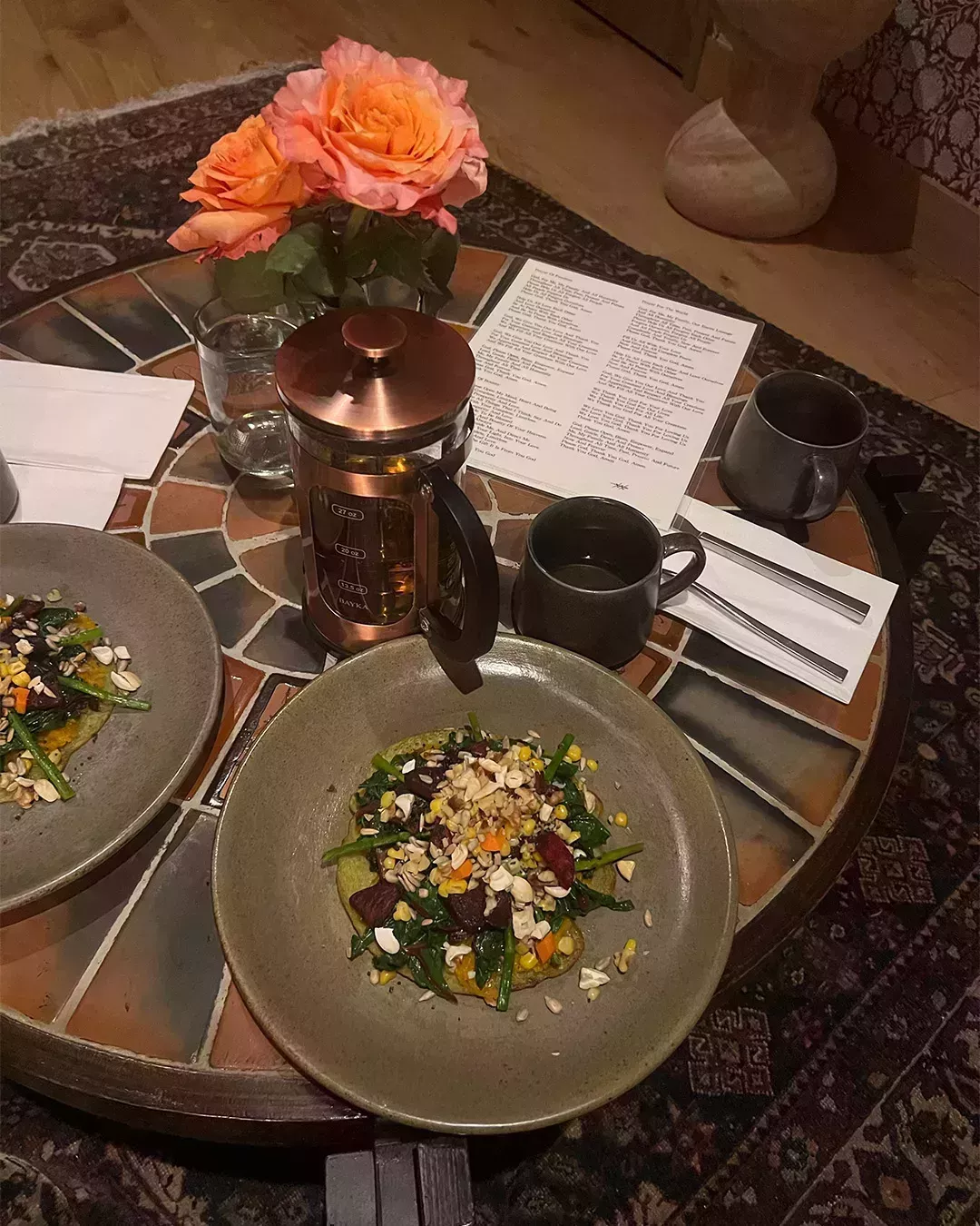 photo of a dinner table with food and a menu