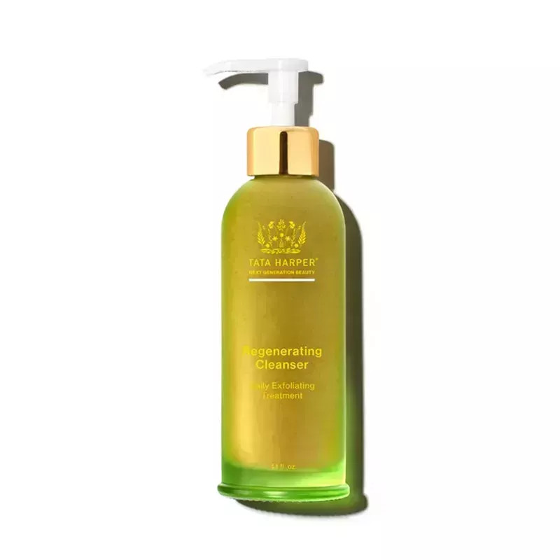 Tata Harper Regenerating Cleanser: A green glass pump bottle with a white pump and gold cap on a white background