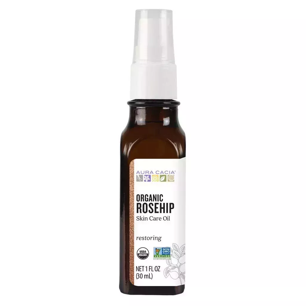 Aura Cacia Organic Rosehip Oil mini brown spray bottle with white label and spray cap on white background