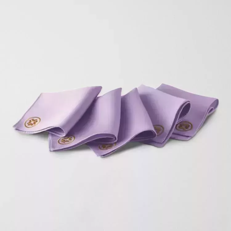 Tatcha Kinu Exfoliating Silk Polishing Face Cloth five folded purple face cloths on gray background