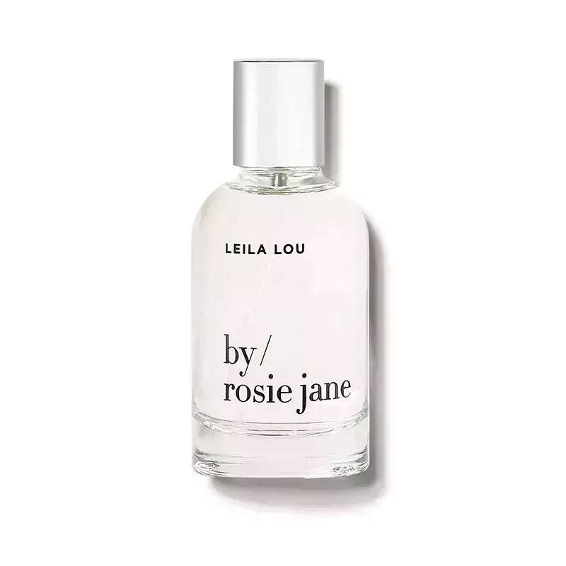 By Rosie Jane Leila Lou Eau de Parfum: A clear glass perfume bottle with black text on a white background