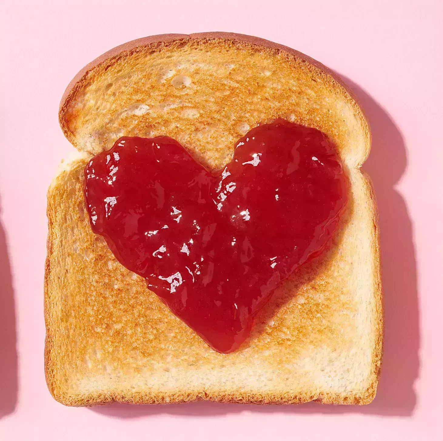 toast with heart shaped jam closeup from above