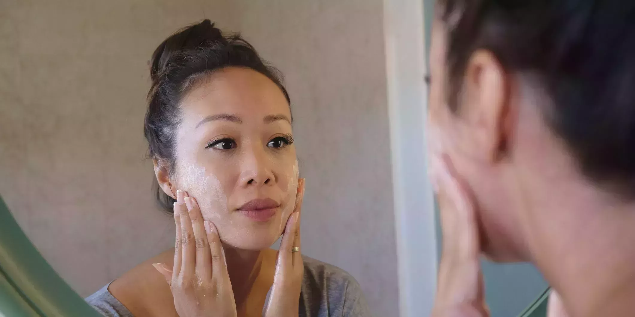 indonesian woman washing her face using beauty cleanser soap