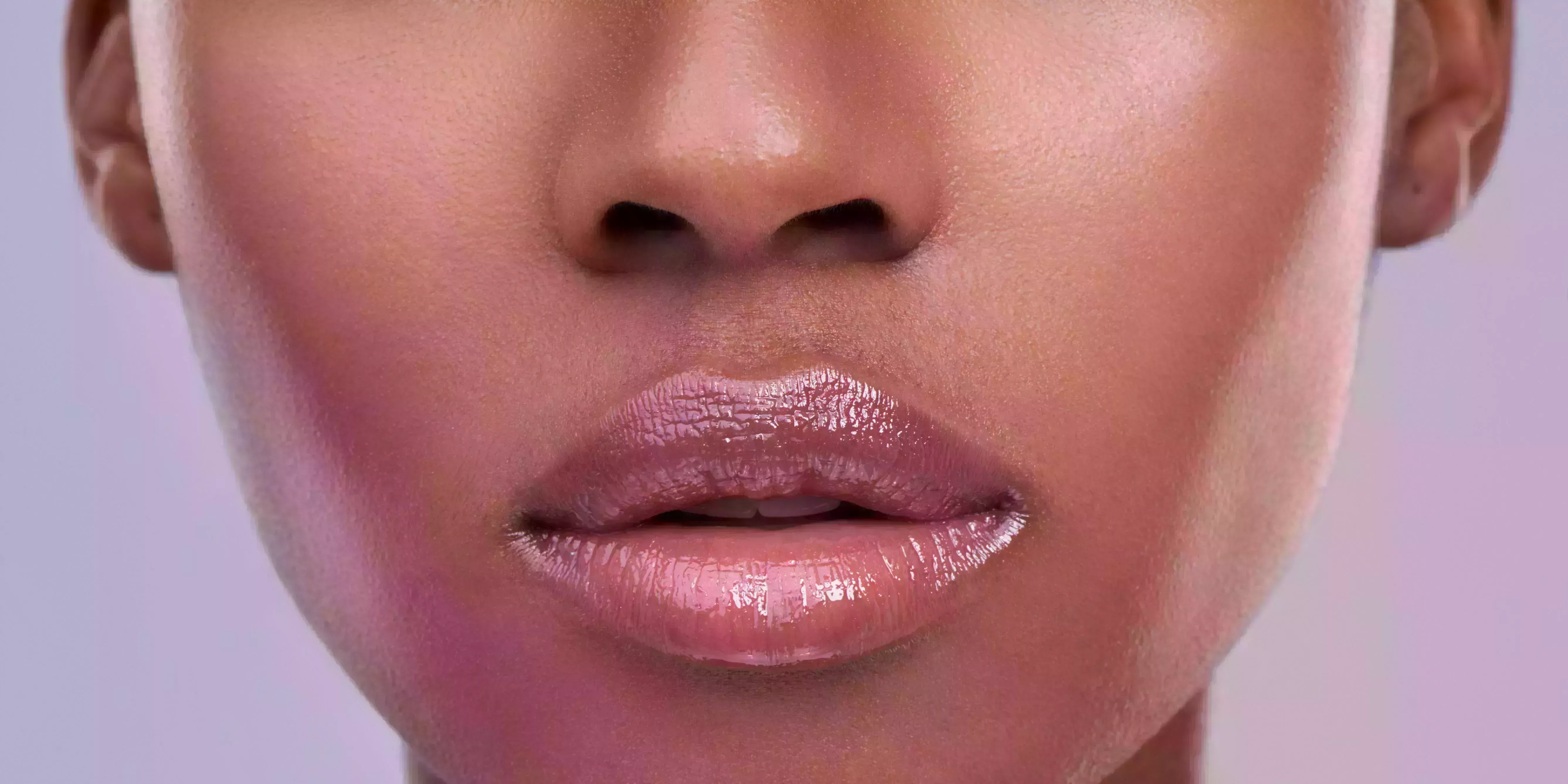 cropped shot of a young womans mouth against a purple background