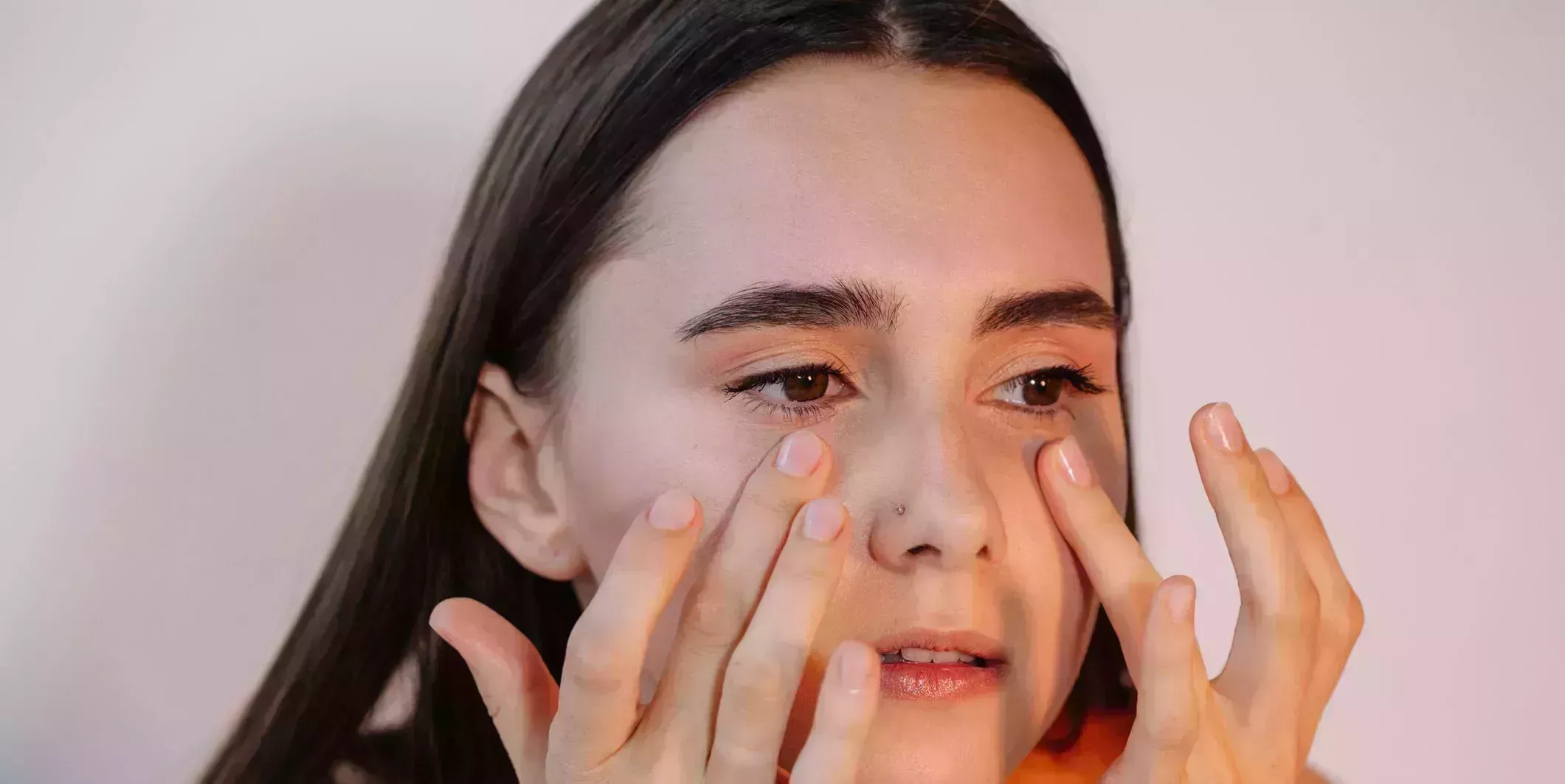 woman applying eye cream