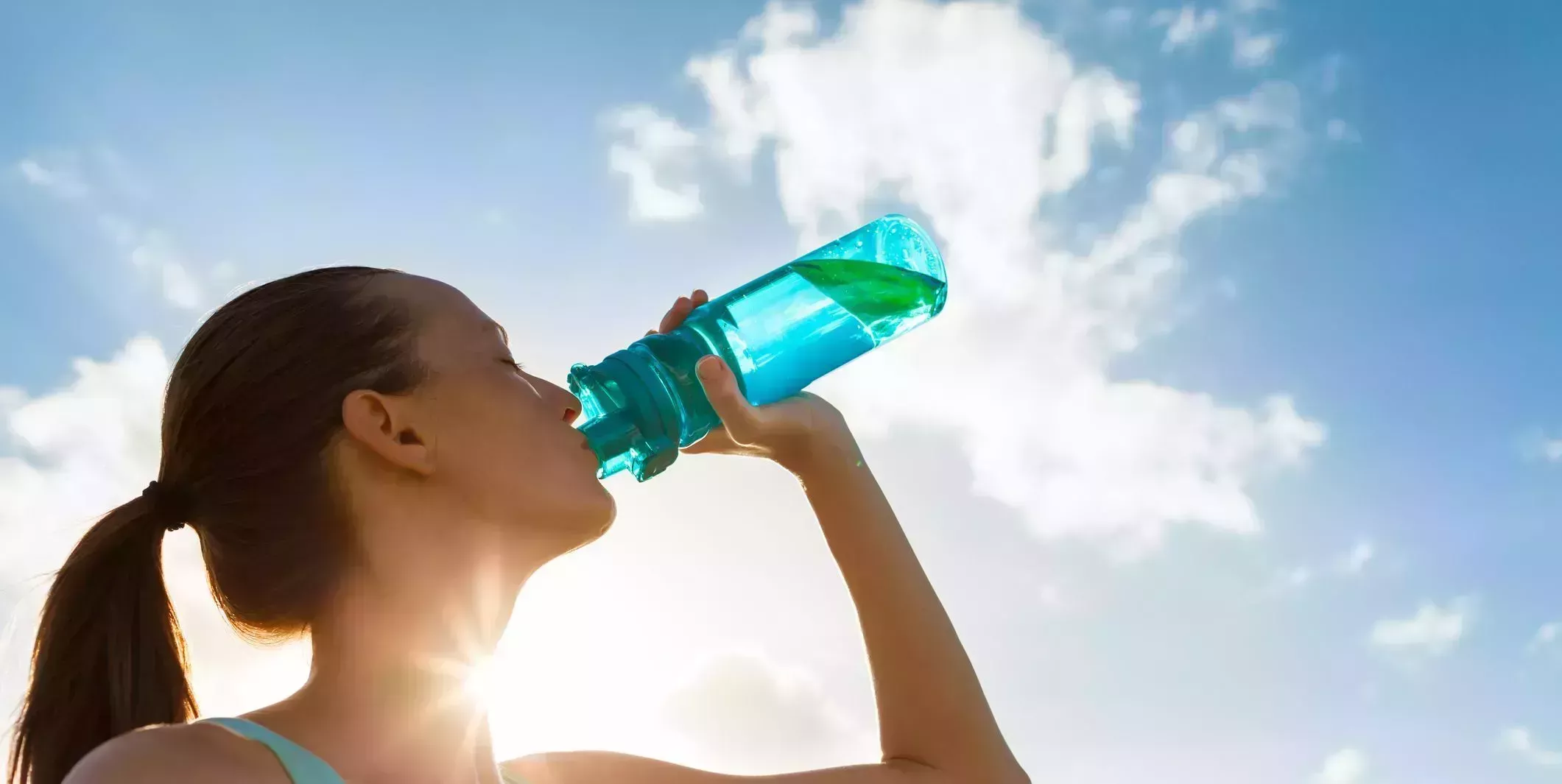 Woman working out drinking water