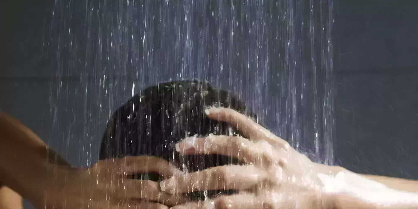 a pair of hands holding a piece of wood