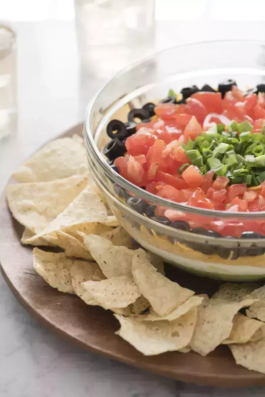 close up of layered dip with tortilla chips