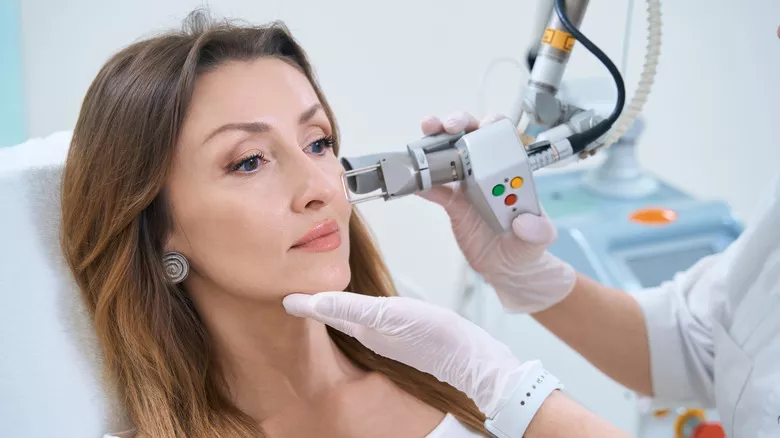 woman receiving professional acne treatment