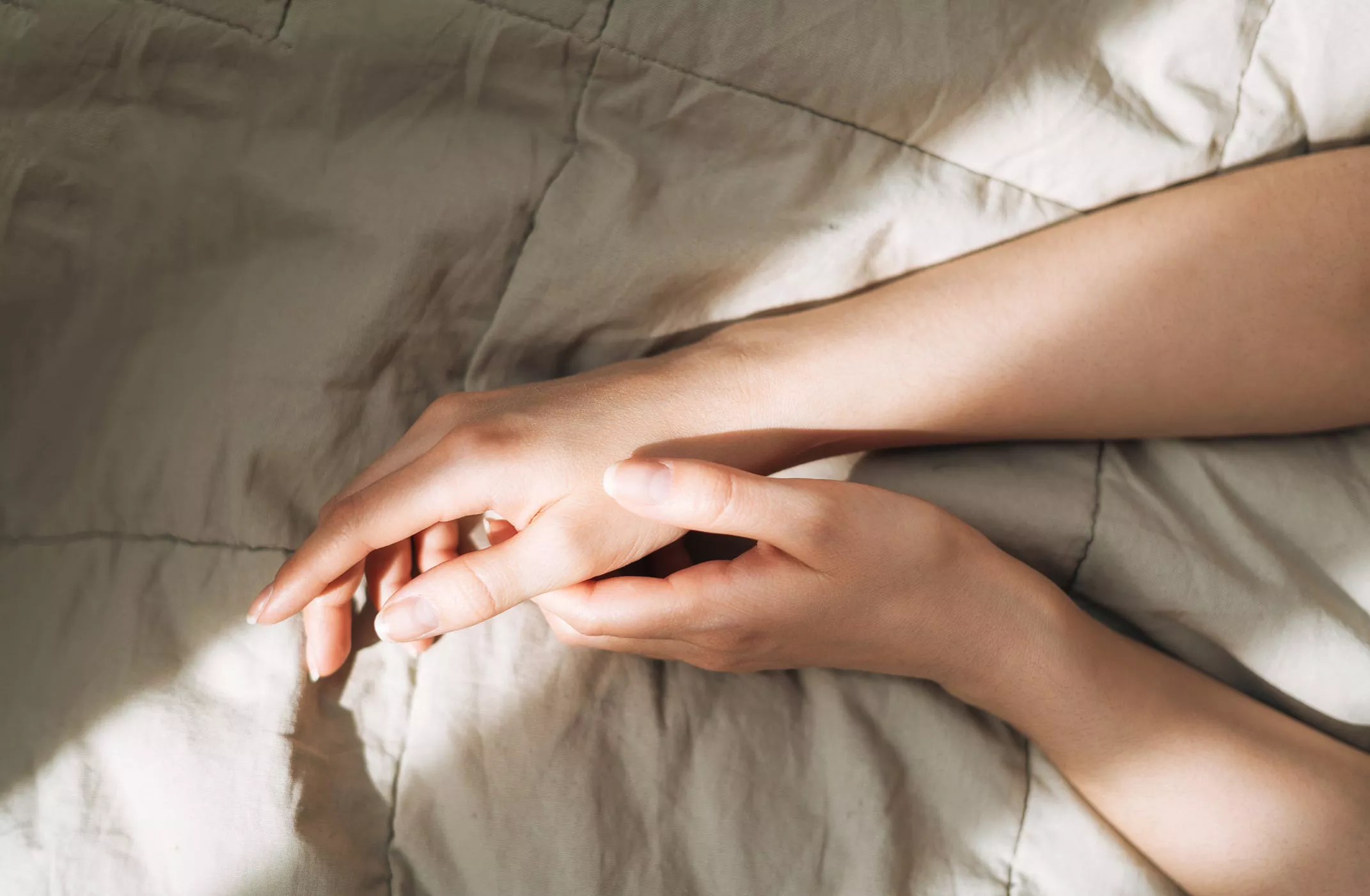 Beautiful female hands on the blanket